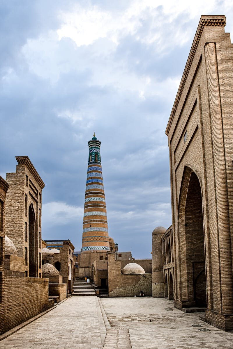 Discover the historic Islam Khoja Minaret and Shergazi Khan Madrasah in Khiva, Uzbekistan's Old Town.
