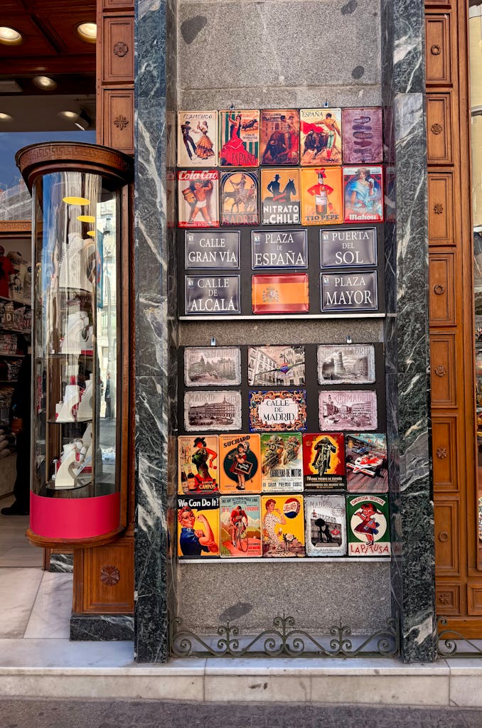 Colorful vintage posters on a street in Madrid, Spain, capturing the city's vibrant culture.