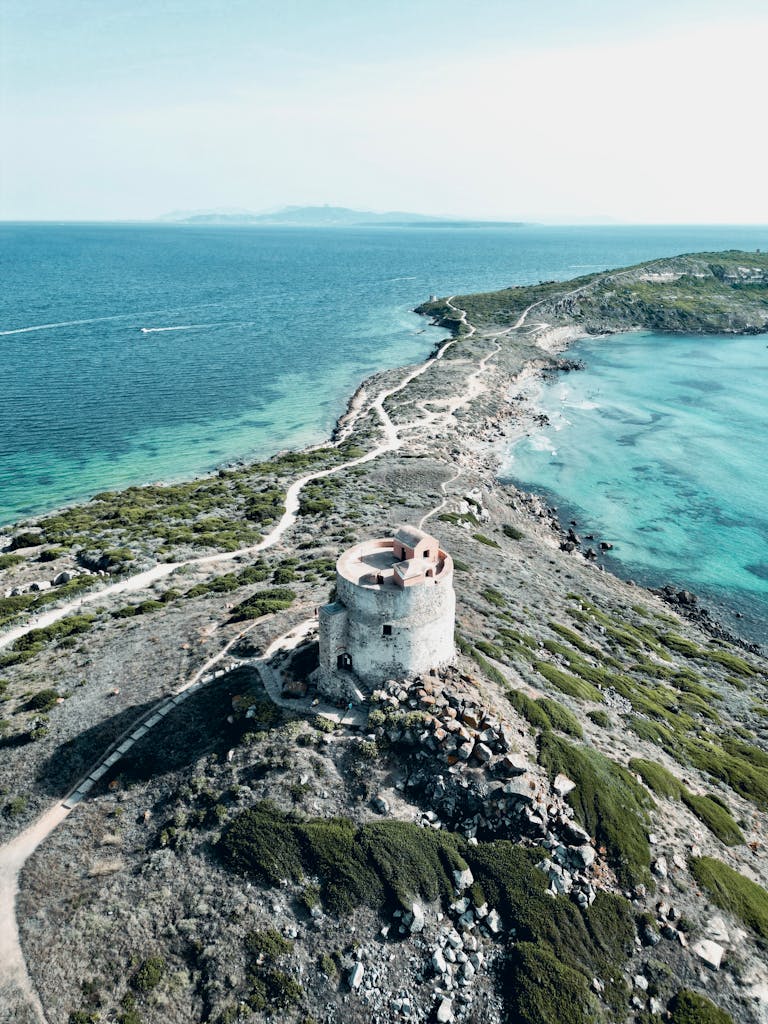 Drone shot of Torre Capo San Marco overlooking the pristine coastline in Italy.